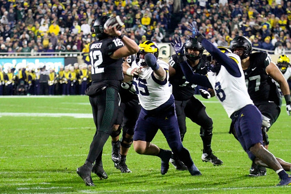 Mason Graham (55) and Derrick Moore (8)