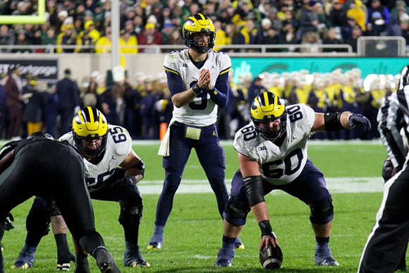 Zak Zinter (65), J.J. McCarthy (9), and Drake Nugent (60)