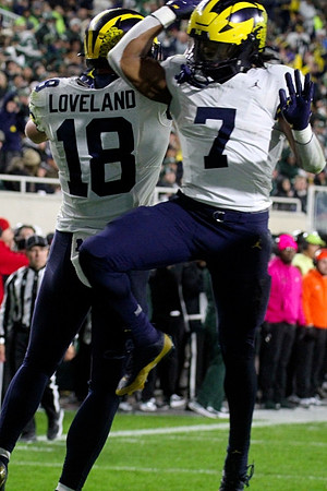 Colston Loveland (18) and Donovan Edwards (7)
