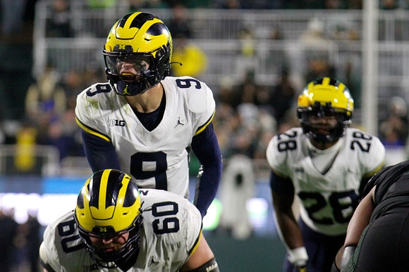 Drake Nugent (60), J.J. McCarthy (9), and Benjamin Hall (28)