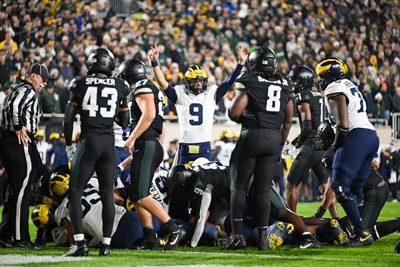 Zak Zinter (65), Colston Loveland (18), J.J. McCarthy (9), and LaDarius Henderson (73)
