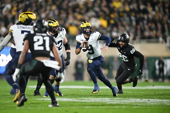 Donovan Edwards (7), Karsen Barnhart (52), and J.J. McCarthy (9)