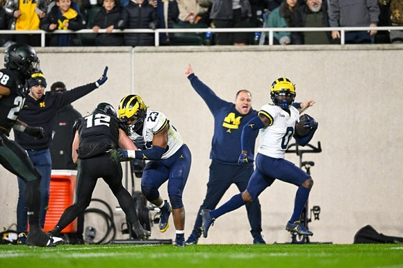 Michael Barrett (23) and Mike Sainristil (0)