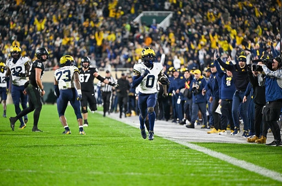 Josh Wallace (12), Jaylen Harrell (32), Michael Barrett (23), and Mike Sainristil (0)