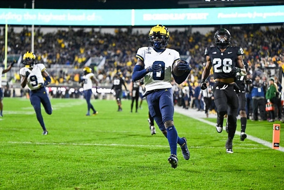 Rod Moore (9) and Mike Sainristil (0)