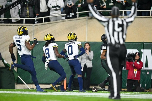 Josaiah Stewart (5), Rod Moore (9), and Mike Sainristil (0)