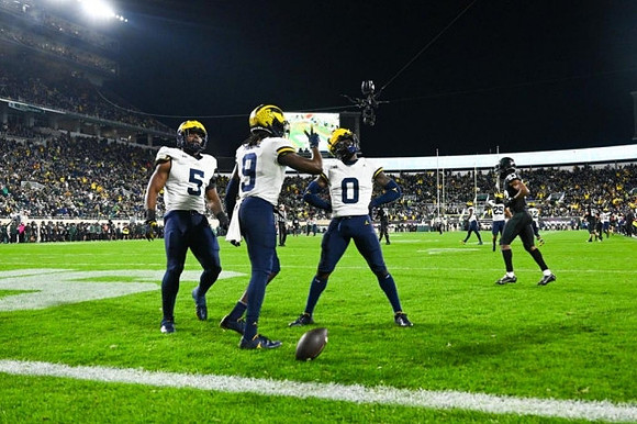Josaiah Stewart (5), Rod Moore (9), and Mike Sainristil (0)