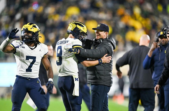 Donovan Edwards (7), J.J. McCarthy (9), and Jim Harbaugh