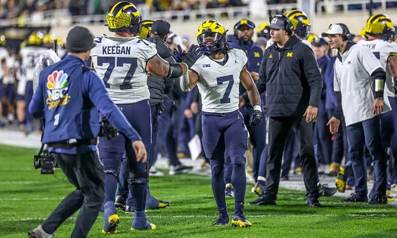 Trevor Keegan (77) and Donovan Edwards (7)