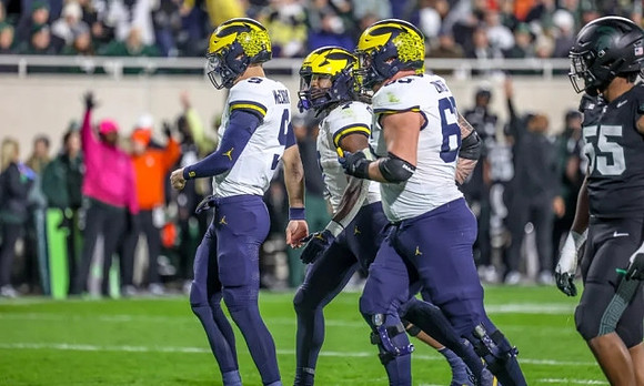 J.J. McCarthy (9), Donovan Edwards (7), and Zak Zinter (65)