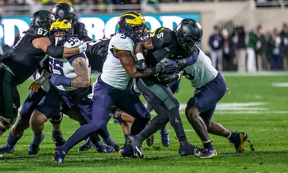Mason Graham (55) and Rod Moore (9)