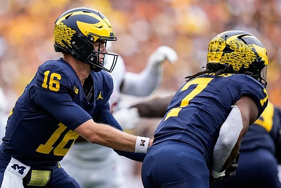 Davis Warren (16) and Donovan Edwards (7)