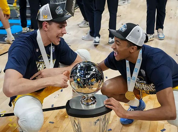 Vladislav Goldin (50), Nimari Burnett (4), and Big Ten Tournament Championship Trophy