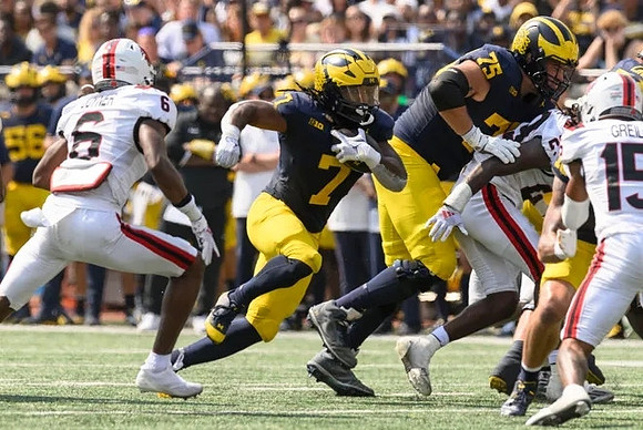 Donovan Edwards (7) and Andrew Gentry (75)