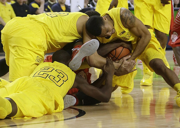 Caris LeVert (23), Jordan Morgan (52), and Trey Burke (3)