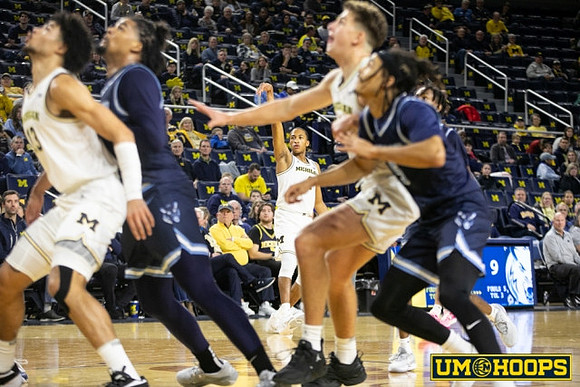 Nimari Burnett (4), Olivier Nkamhoua (13), and Will Tschetter (42)