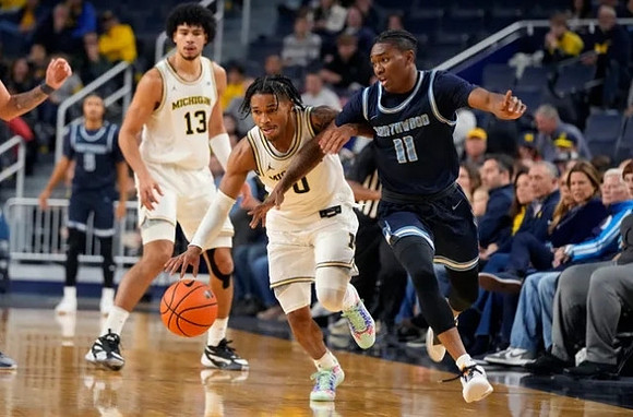Dug McDaniel (0) and Olivier Nkamhoua (13)