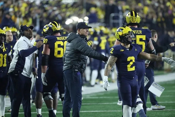 Ron Bellamy, Drake Nugent (60), Jim Harbaugh, Blake Corum (2), and Zak Zinter (65)