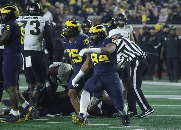 Derrick Moore (8), Junior Colson (25), and Kris Jenkins (94)