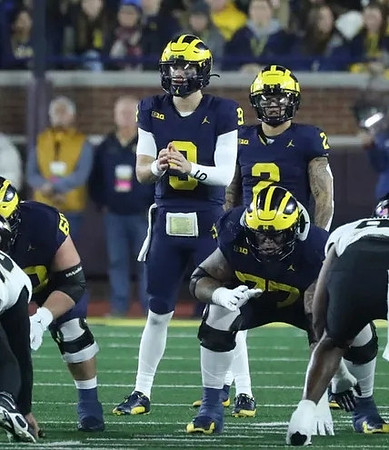 Drake Nugent (60), J.J. McCarthy (9), Blake Corum (2), and Trevor Keegan (77)