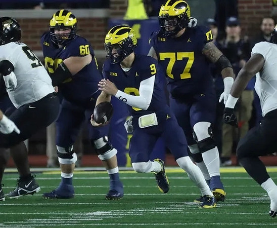 Drake Nugent (60), J.J. McCarthy (9), and Trevor Keegan (77)