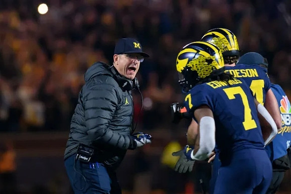 Jim Harbaugh, Donovan Edwards (7), and Max Bredeson (44)