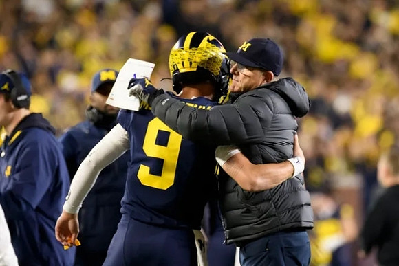 J.J. McCarthy (9) and Jim Harbaugh