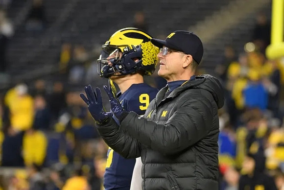 J.J. McCarthy (9) and Jim Harbaugh