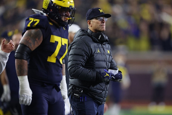 Trevor Keegan (77) and Jim Harbaugh