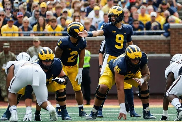 Andrew Stueber (71), Blake Corum (2), J.J. McCarthy (9), and Chuck Filiaga (66)