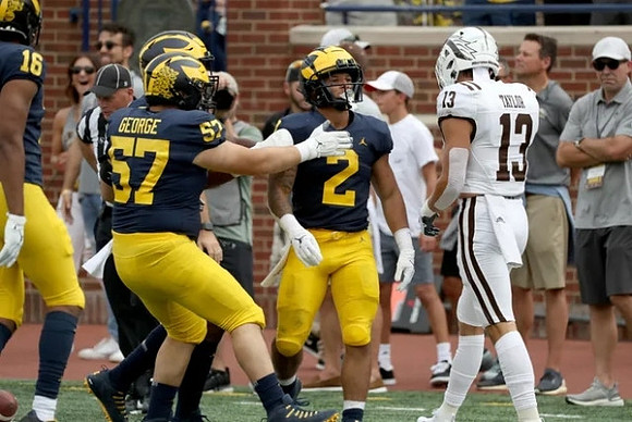 Jalen Perry (16), Joey George (57), and Blake Corum (2)