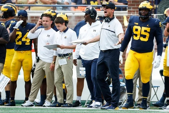 George Johnson (24), Jim Harbaugh, and Donovan Jeter (95)