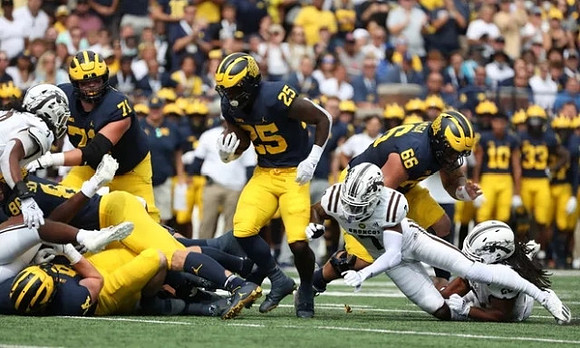 Hassan Haskins (25), Andrew Stueber (71), and Chuck Filiaga (66)