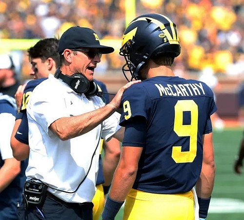 Cade McNamara (12), Jim Harbaugh, and J.J. McCarthy (9)