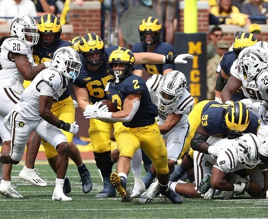 Blake Corum (2), Zak Zinter (65), and Trente Jones (53)