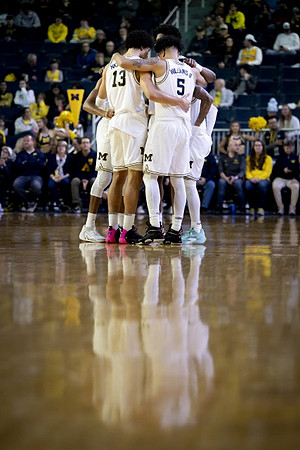 Olivier Nkamhoua (13), Terrance Williams II (5), and Michigan Team