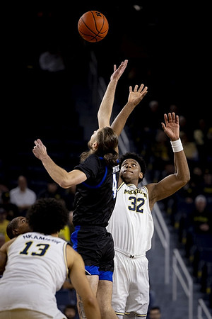 Olivier Nkamhoua (13) and Tarris Reed Jr. (32)