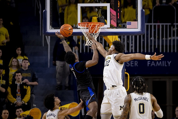 Olivier Nkamhoua (13), Tarris Reed Jr. (32), and Dug McDaniel (0)