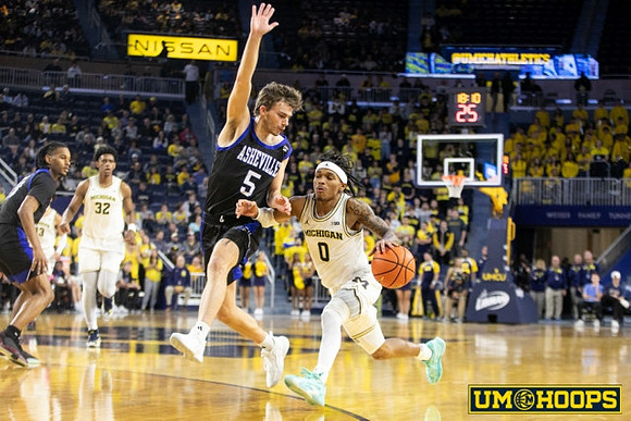 Olivier Nkamhoua (13), Tarris Reed Jr. (32), and Dug McDaniel (0)