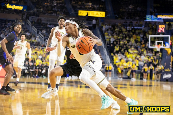 Olivier Nkamhoua (13), Tarris Reed Jr. (32), and Dug McDaniel (0)