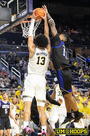 Olivier Nkamhoua (13) and Tarris Reed Jr. (32)