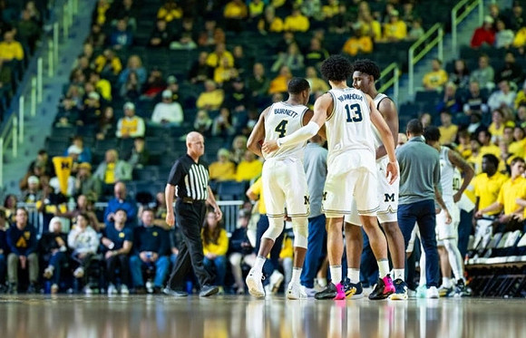 Nimari Burnett (4), Olivier Nkamhoua (13), and Tarris Reed Jr. (32)