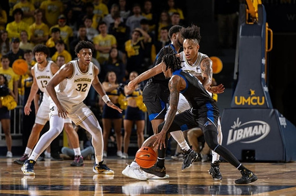 Olivier Nkamhoua (13), Tarris Reed Jr. (32), and Terrance Williams II (5)