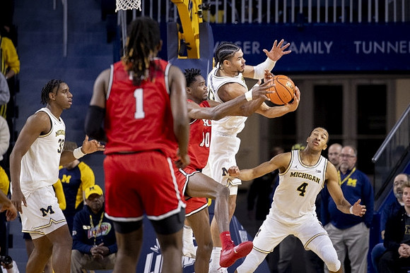 Tarris Reed Jr. (32), Olivier Nkamhoua (13), and Nimari Burnett (4)