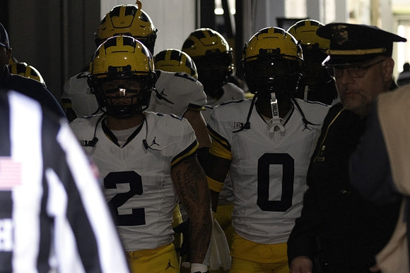 Will Johnson (2), Mike Sainristil (0), and Michigan Team