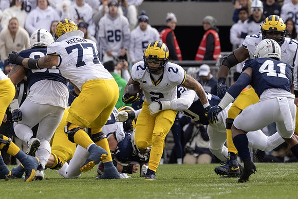 Trevor Keegan (77), Blake Corum (2), and LaDarius Henderson (73)