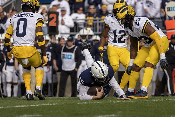 Mike Sainristil (0), Josh Wallace (12), and Michael Barrett (23)