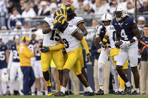 Ernest Hausmann (15), Rod Moore (9), and Mike Sainristil (0)