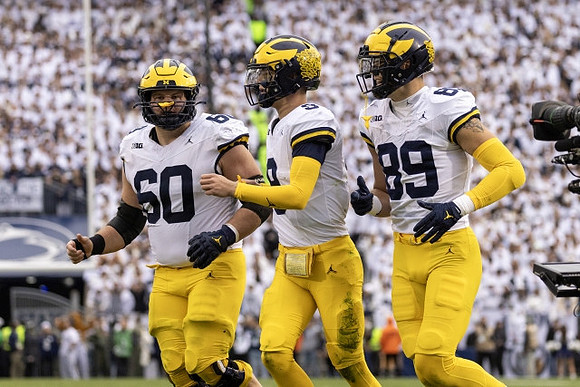 Drake Nugent (60), J.J. McCarthy (9), and AJ Barner (89)