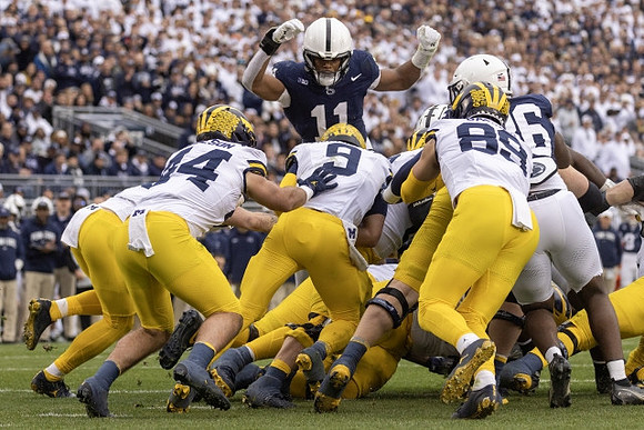 Max Bredeson (44), J.J. McCarthy (9), and AJ Barner (89)